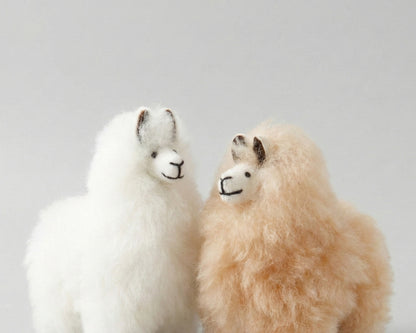 Front view of white and beige alpaca keychains with sweet facial details