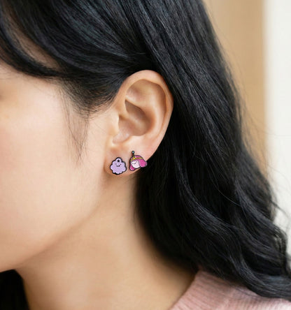 Model wearing Adventure Time Princess Bubblegum and LSP pink purple earrings on earlobe