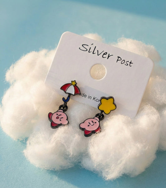 Kirby drop earrings with red umbrella and yellow star designs displayed on white fluffy cotton, mounted on a "Silver Post" card.