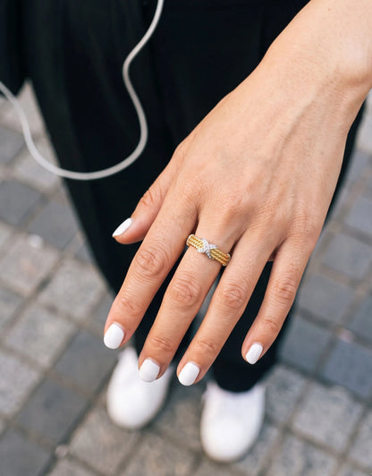 Downtown girl OOTD holding wine glass, gold twisted rope ring as daily luxury accent.