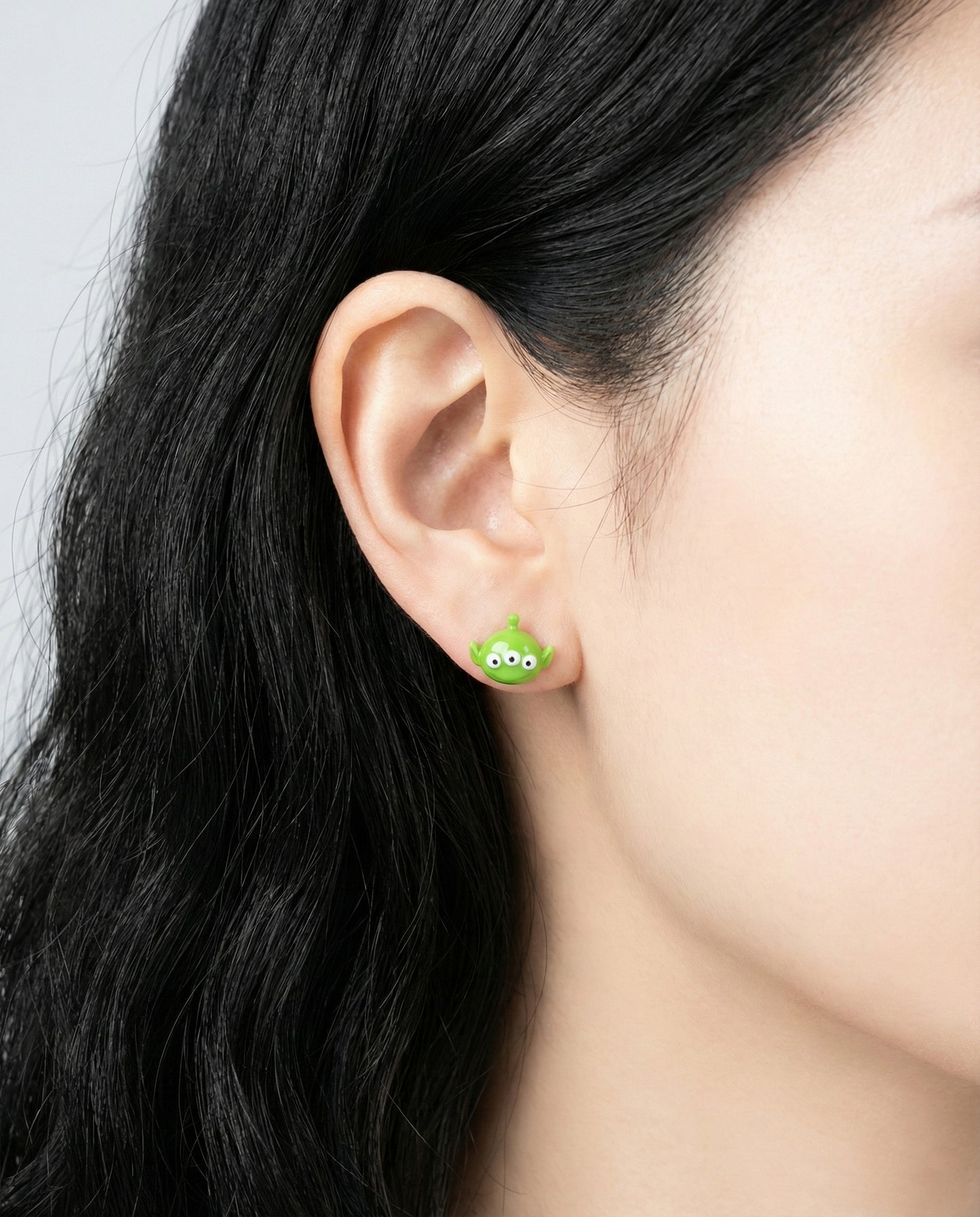 Toy Story Alien lime green stud earring on ear - kawaii Disney character jewelry set