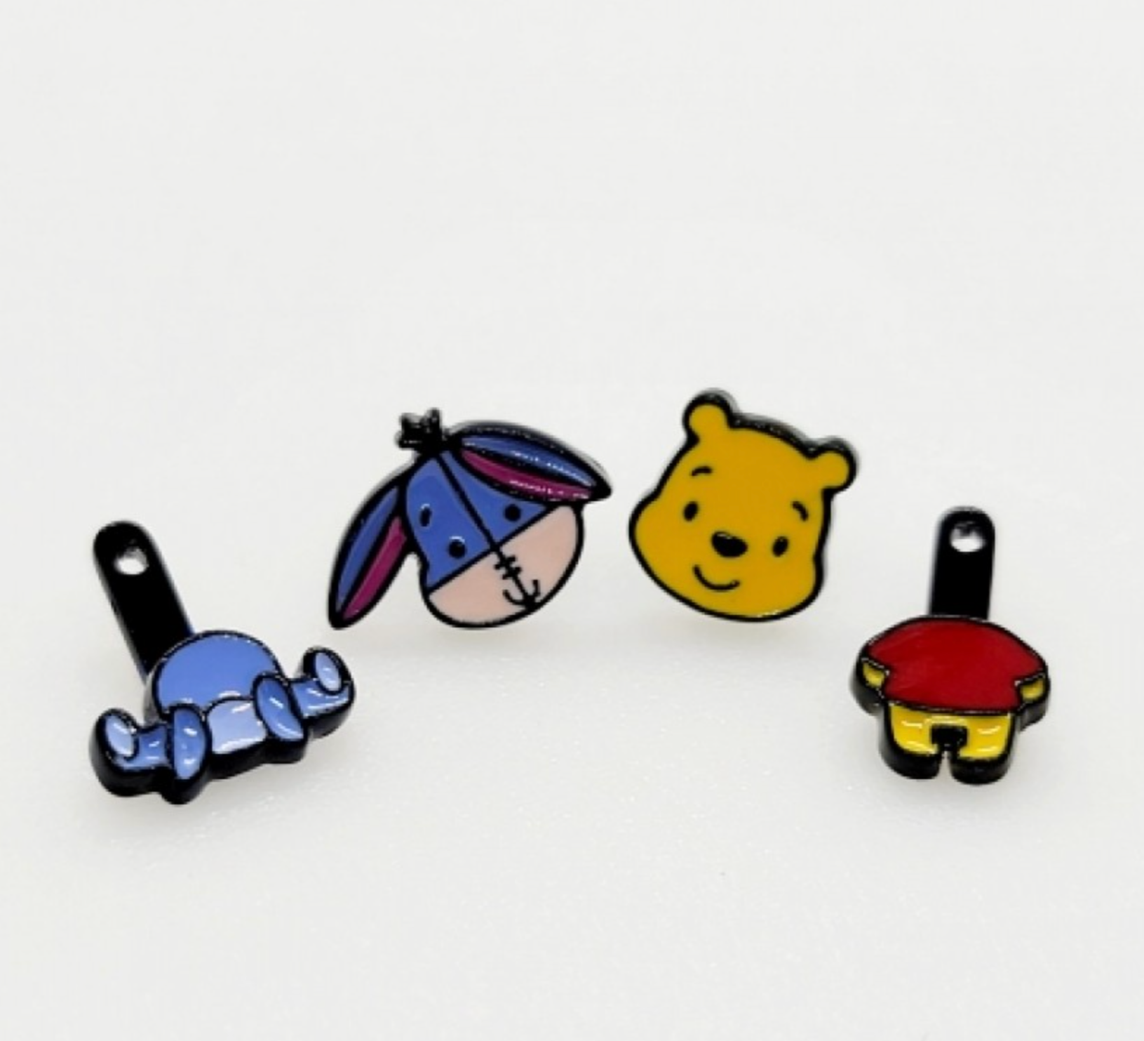 Close-up of the front head studs and the back body attachments of the Pooh and Eeyore two-way earrings