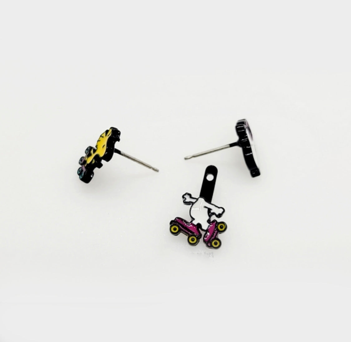 Disassembled Snoopy ear jacket earring showing front stud and back skating piece with silver posts