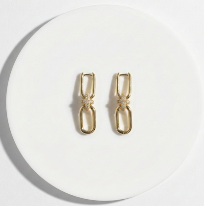  Flat lay of gold chain knot earrings on white background, jewelry product photography