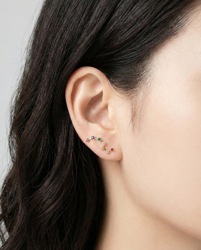 Model wearing rainbow Big Dipper ear climber on earlobe showing constellation design