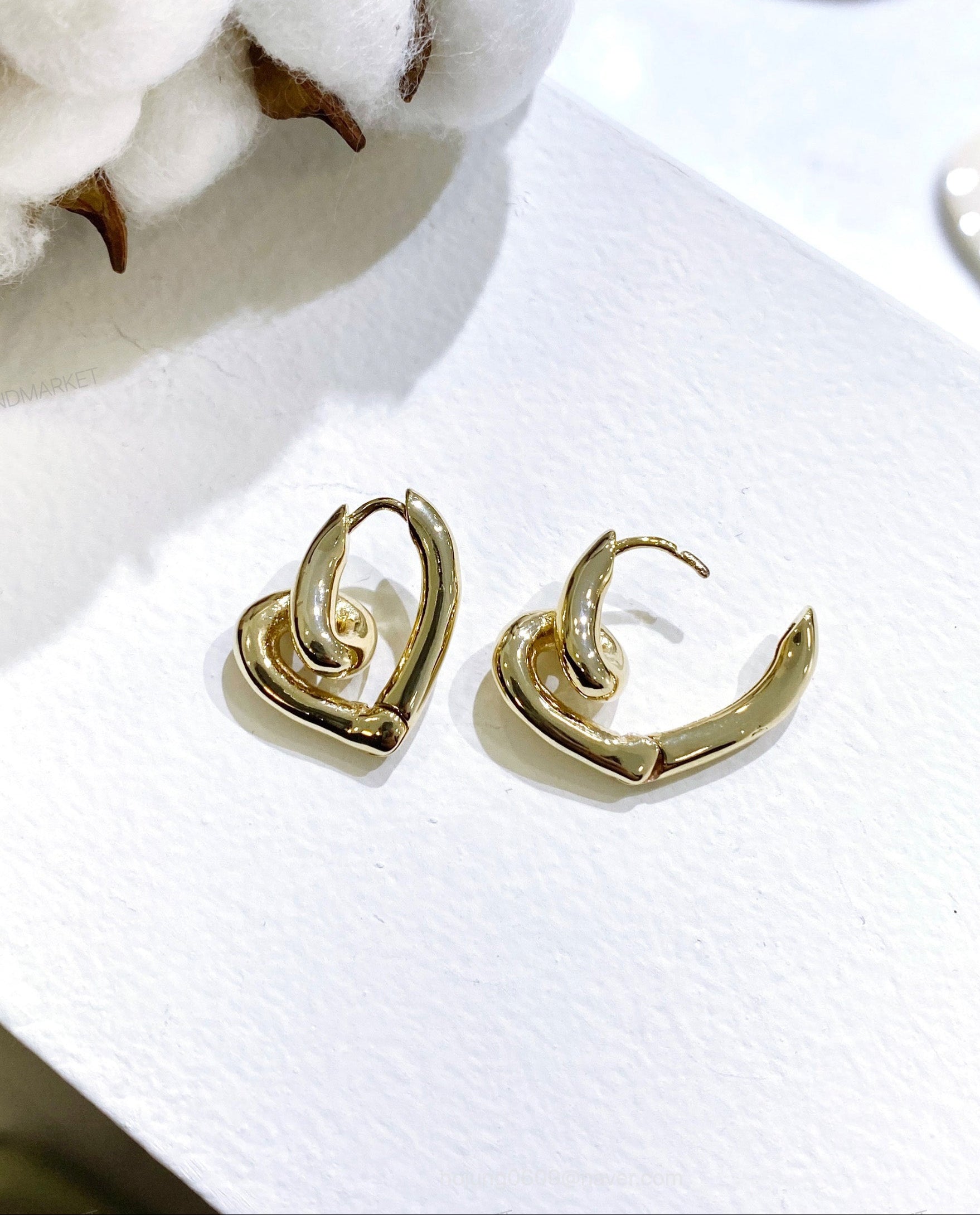 Gold twisted love knot heart earrings shown open and closed, clicker mechanism detail