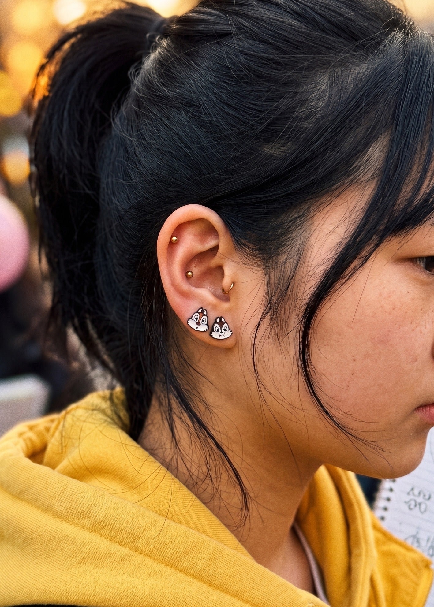 Chip Disney enamel barbell stud close-up at sunset, cute character inner conch piercing, K-fashion accessory gift idea for teens
