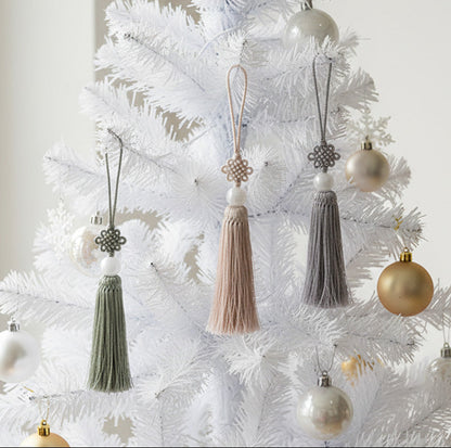 Korean norigae tassel charms in mint, beige and light blue hanging on white Christmas tree with ornaments