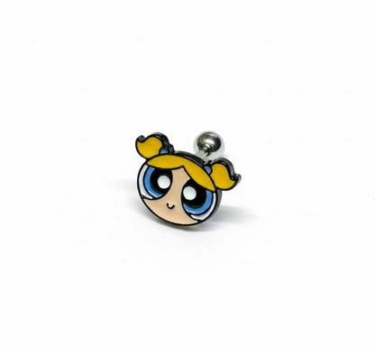 close-up of a Powerpuff Girls–inspired yellow-haired character barbell earring on a white background.