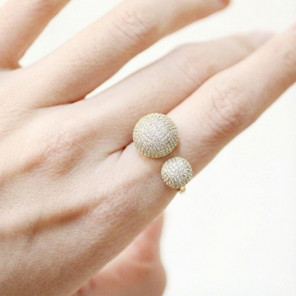 Gold crystal dome open ring worn on hand, showcasing bold double sphere design