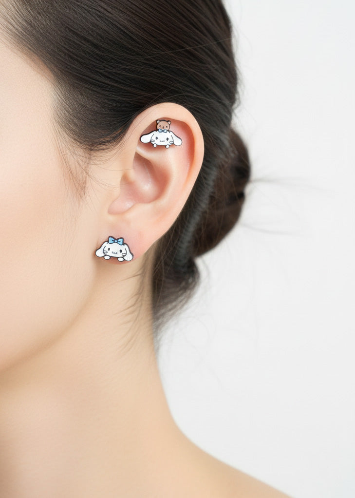 Cinnamoroll surgical steel mini piercing worn on lobe and cartilage, showing adorable teddy bear and ribbon designs, hypoallergenic Sanrio earrings