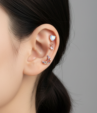 Close-up of a person wearing colorful earrings with a gray background