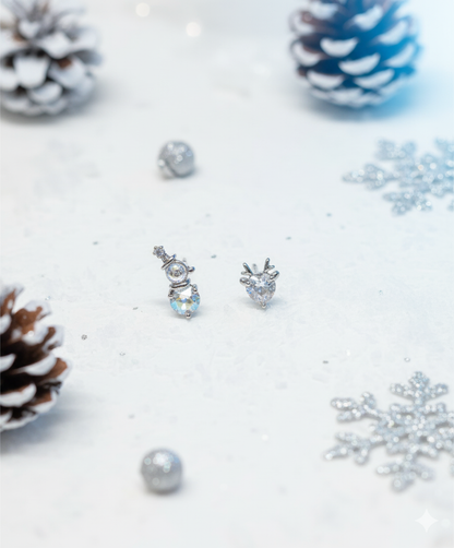 Snowman & reindeer set on glossy white surface — reflective holiday barbell-ball earrings product photo