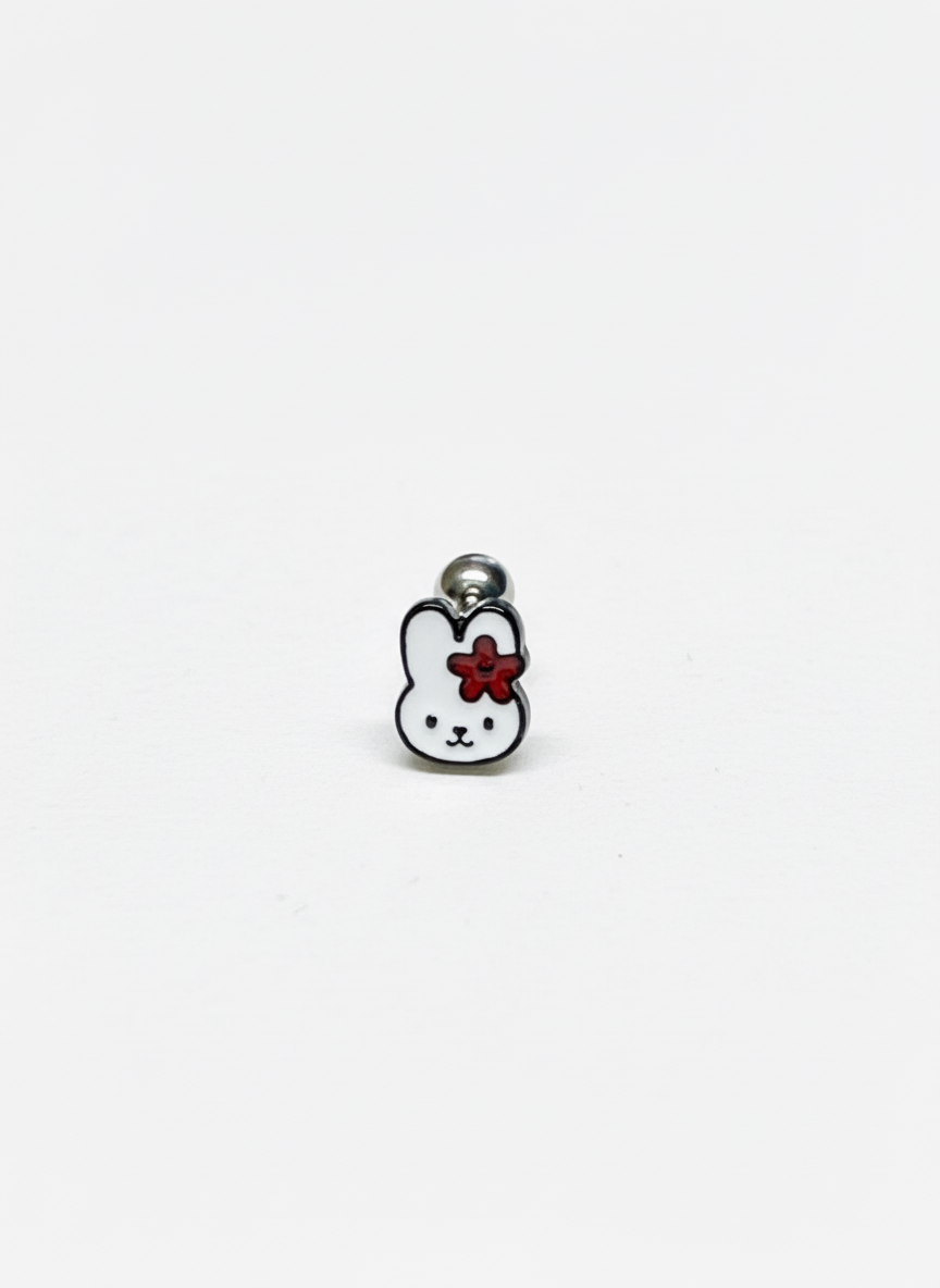 Close-up of a single barbell earring shaped like Miffy with a red flower on her ear, against a clean white background.