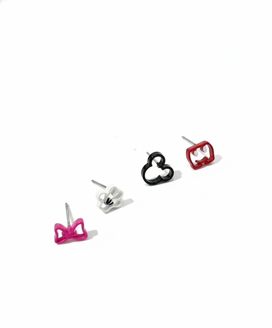 Flat lay of four Mickey-themed earrings — pink bow, white glove, black silhouette, and red pants — arranged in a row on a white background.