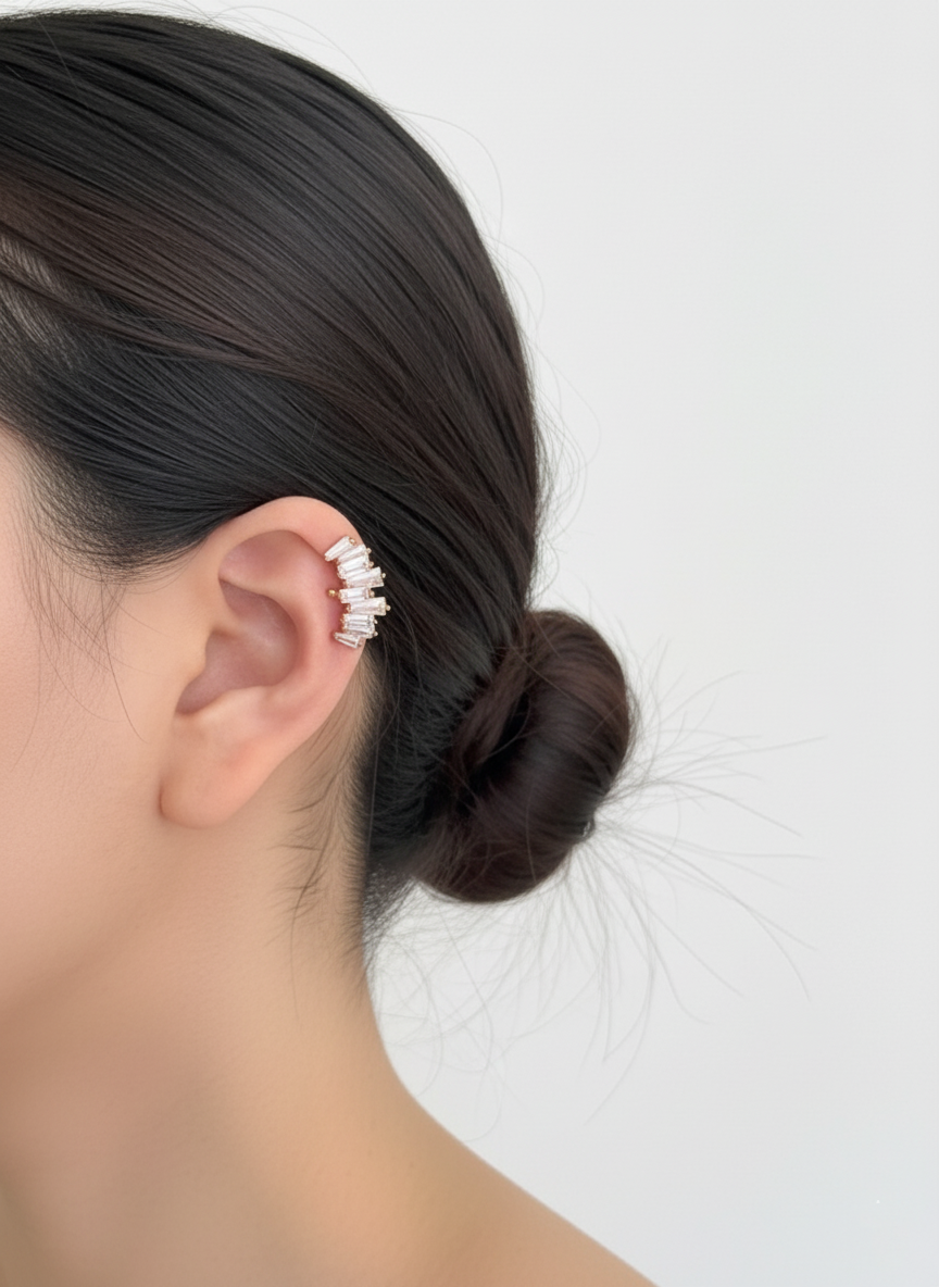 Gold baguette-cut cubic zirconia ear cuff positioned on the upper ear cartilage, brass material, handmade in Korea.