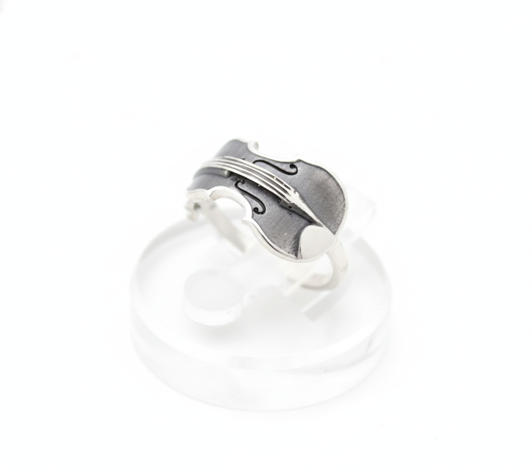Handcrafted musical instrument ring in 925 silver on white studio background.