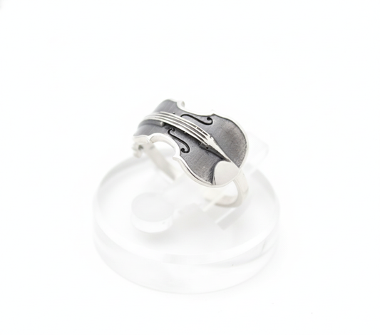 Handcrafted musical instrument ring in 925 silver on white studio background.