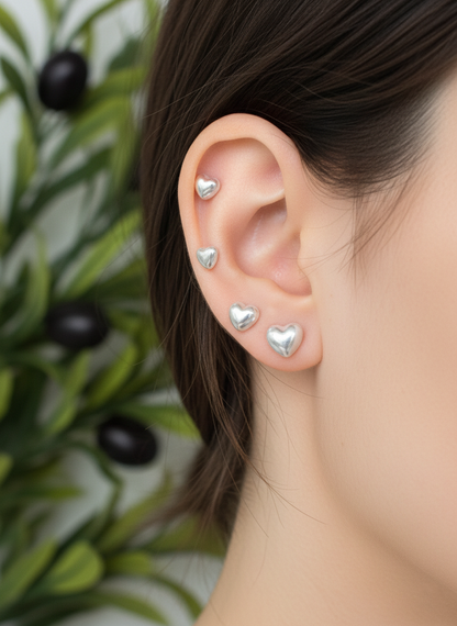 Aurora heart pearl barbell earrings worn on ear showing helix and lobe piercings