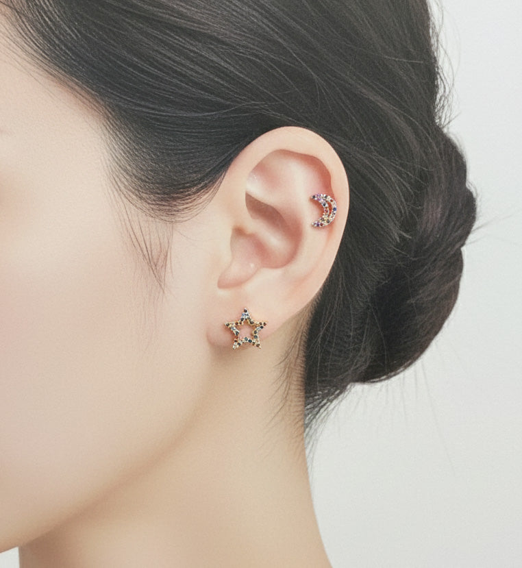 Woman wearing rainbow cubic zirconia moon helix piercing