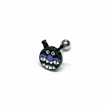 Black Baikinman barbell earring with wide toothy grin on white background.