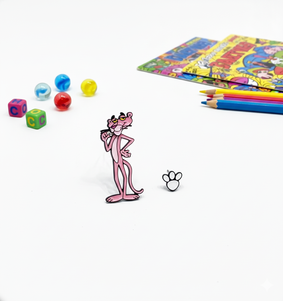 Standing Pink Panther charm earring and white paw stud arranged upright on a white surface with colorful beads, comic books, and pencils nearby.