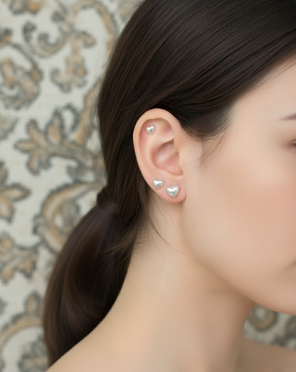 Aurora heart pearl barbell earrings worn on ear showing helix and lobe piercings
