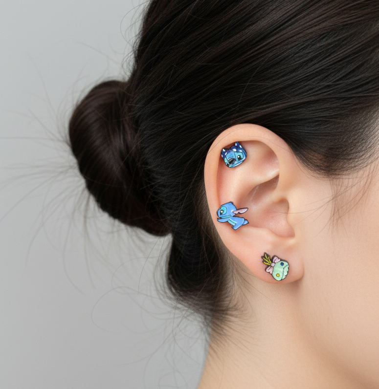 Three Lilo & Stitch barbell earrings worn on ear - Stitch on helix, Scrump on conch, Angel on lobe
