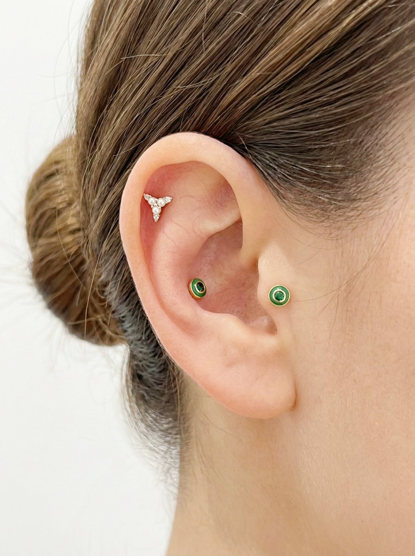 Green cubic epoxy barbell earring styled on helix and cartilage.