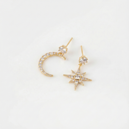 Flat lay of gold moon and north star earrings