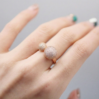 Rose gold double dome ring with full crystal setting, worn on model’s finger