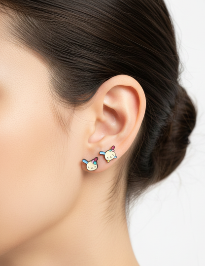 clean studio ear photo wearing two Ussahana-inspired pastel bunny-face barbell studs with blue, pink, and yellow accents