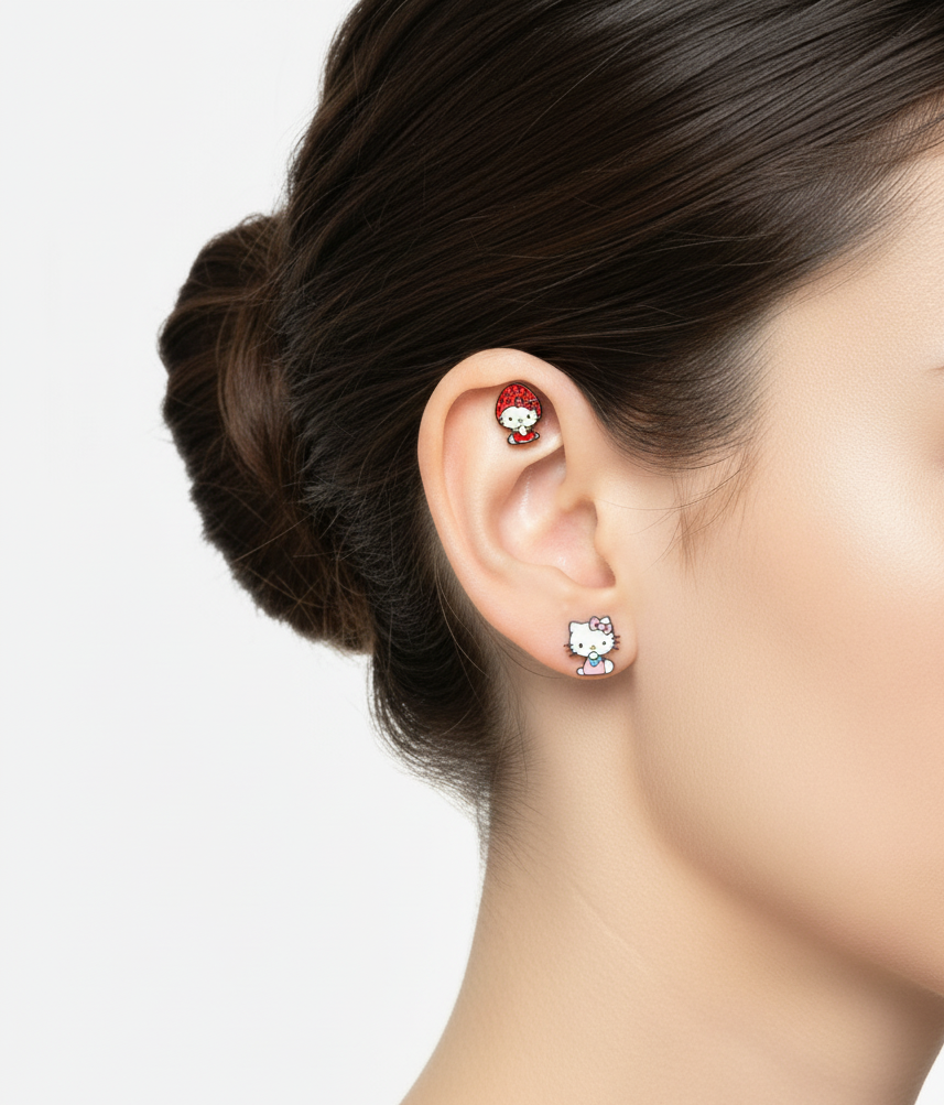Cute Hello Kitty earrings styled with a strawberry hooded character on helix and a pink dress version on the lobe