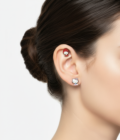 Cute Hello Kitty earrings styled with a strawberry hooded character on helix and a pink dress version on the lobe