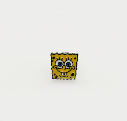 SpongeBob SquarePants enamel barbell earring with yellow face and big blue eyes, shown on a white background