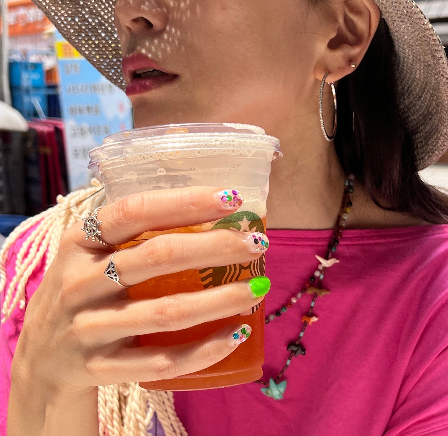 Silver steering wheel ring worn with pink outfit lifestyle shot