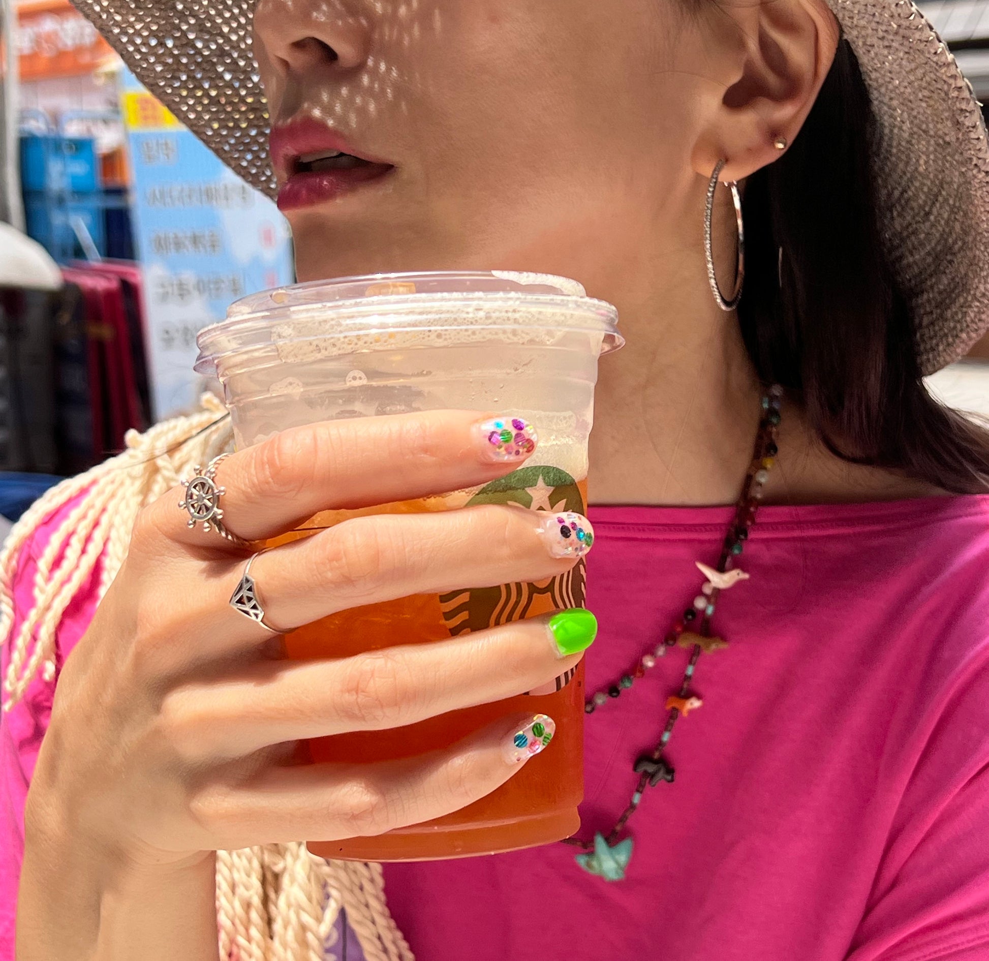 Silver steering wheel ring worn with pink outfit lifestyle shot