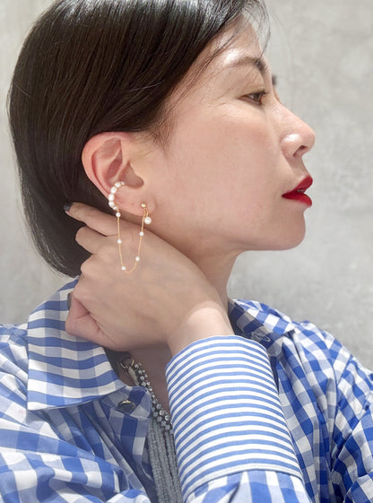 Gold pearl ear cuff worn on model - side view