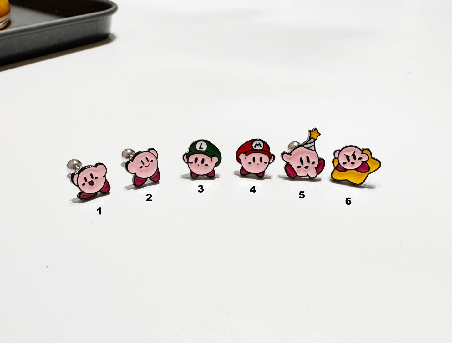Six cute Kirby character earring designs - pink puff, Luigi, Mario, party hat, shooting star
