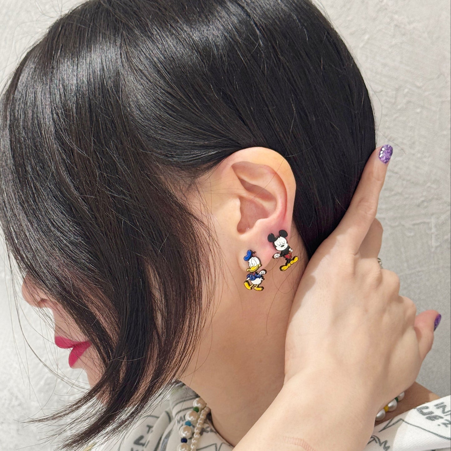 Disney character inspired reversible earrings with Donald and Mickey design in silver