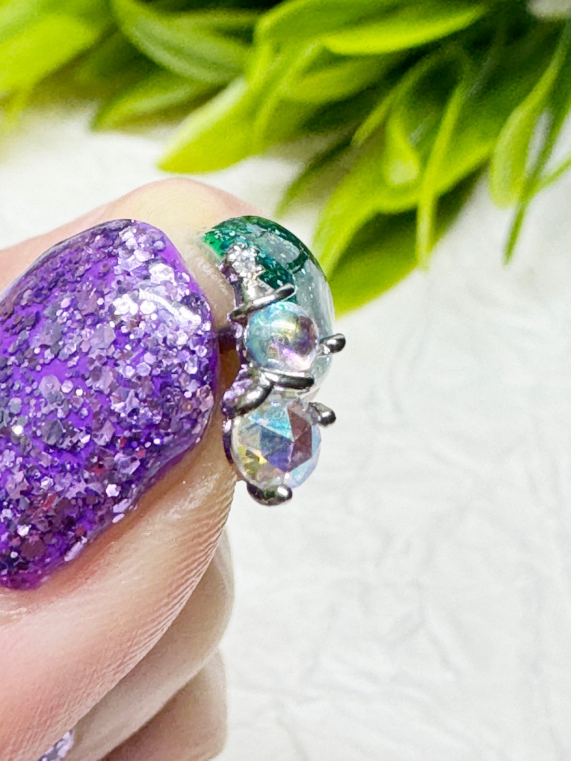 Aurora crystal snowman earring side view — faceted round crystals, mini hat and arms visible