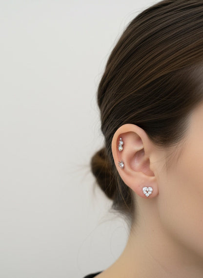 Model ear layered look — helix snowman and reindeer minis with cluster heart stud on the lobe