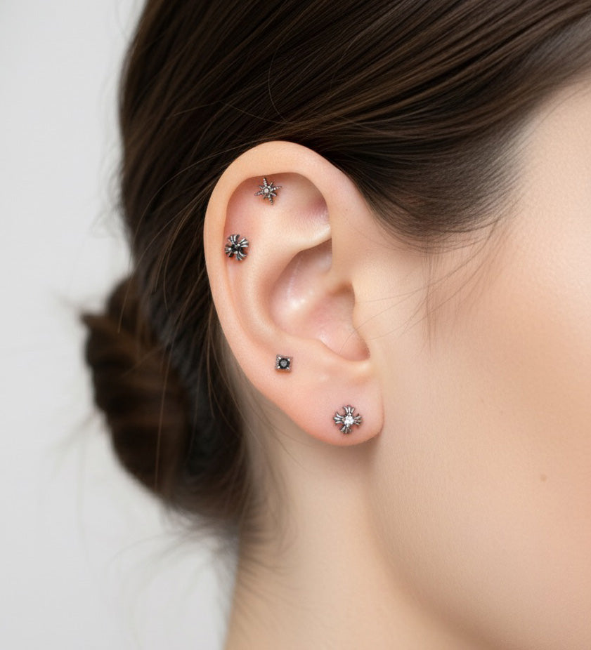 Side profile showing a single minimalist barbell on the inner cartilage. The ear is clean and unadorned, emphasizing a simple, modern vibe.