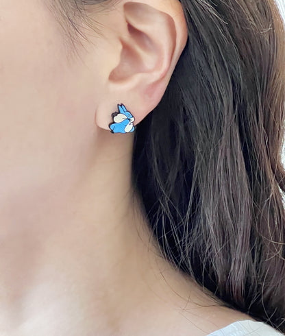 Woman wearing blue bunny Totoro earring, cute kawaii anime jewelry with silver post
