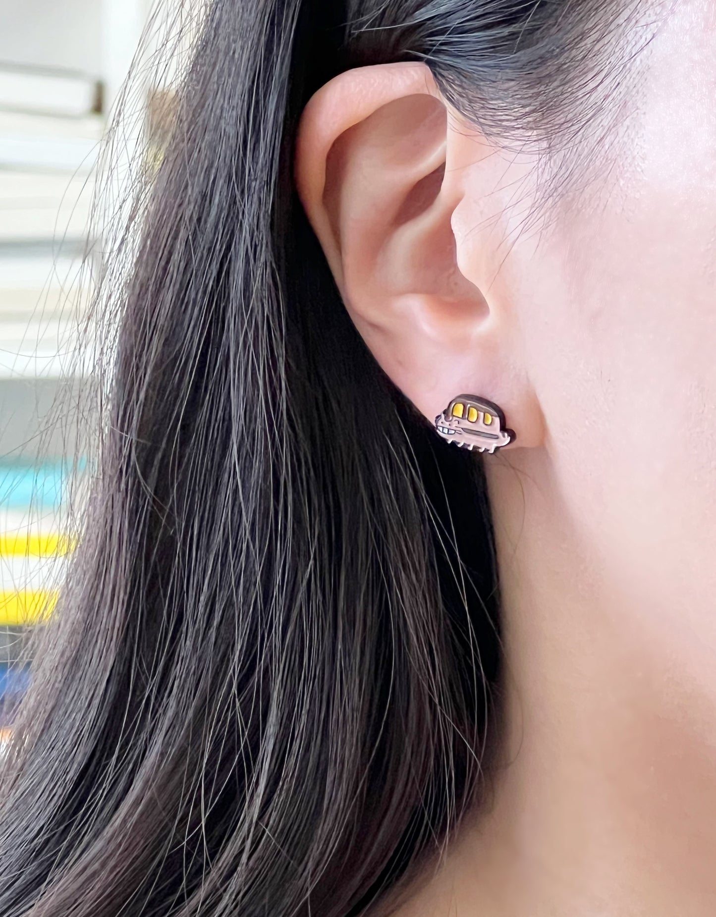 Woman wearing Catbus stud earring on right earlobe daily style