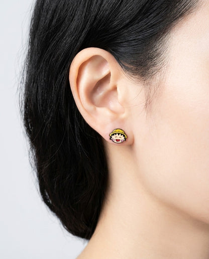 Close-up of yellow hat Maruko-chan character earring worn on ear