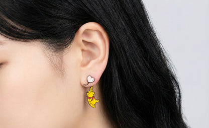Winnie the Pooh balloon earring with pink heart stud worn on ear