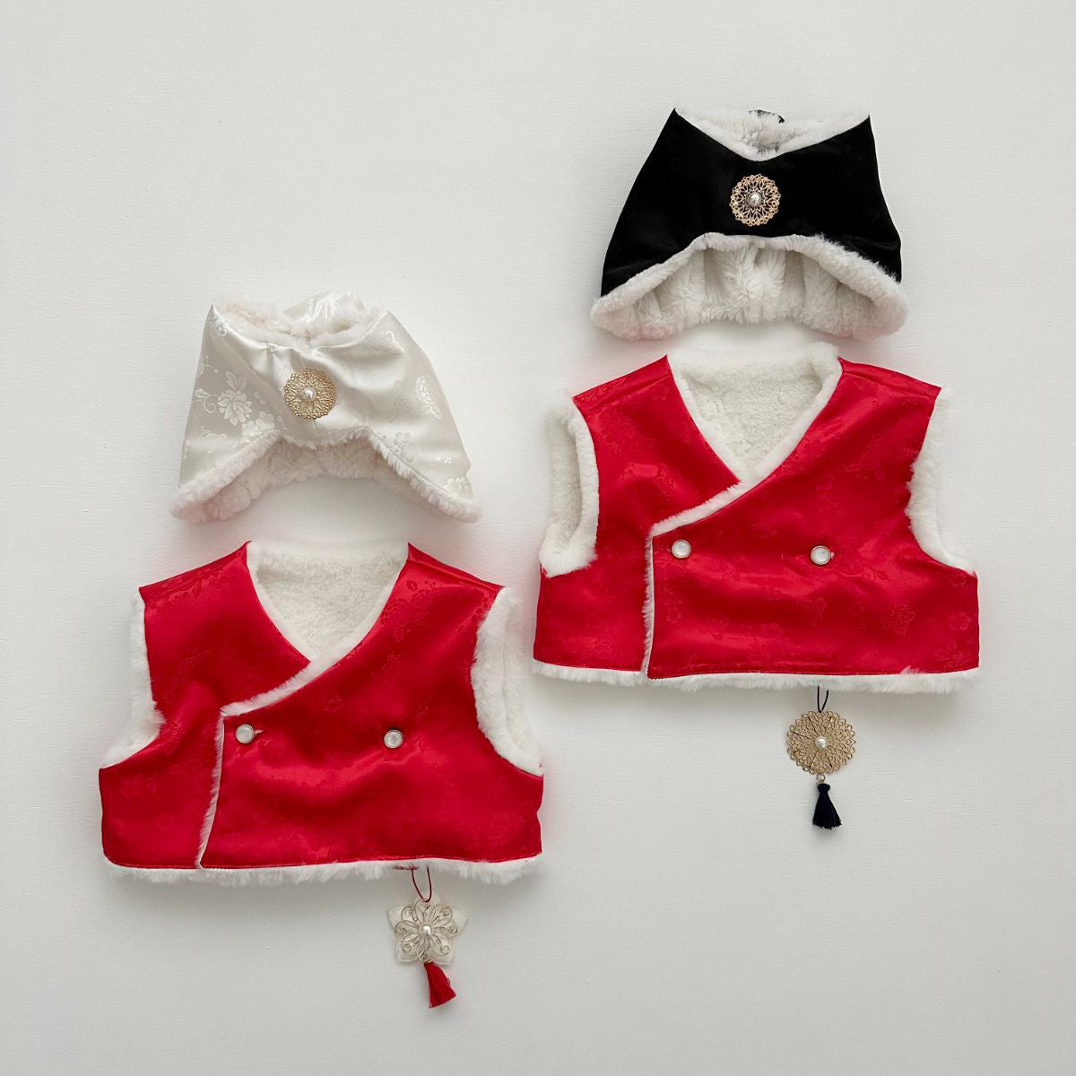 Korean traditional baby hanbok set with Santa-inspired jobawi hats and norigae tassel charms, holiday photoshoot styling
