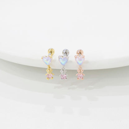 Three heart-shaped and bear earrings in gold, silver, and rose gold on a white background