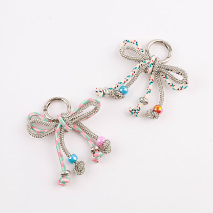 Two rhinestone rope bow bag charms in pink mint and white multi dot close-up comparison